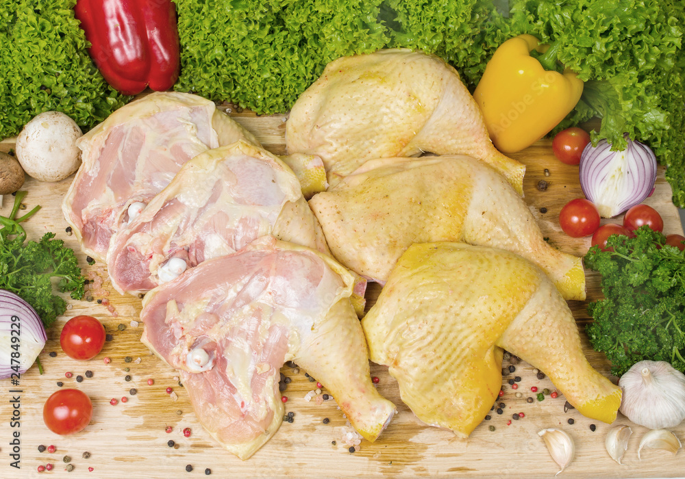 Six pieces of chicken legs with cherry tomatoes, lettuce leaves, garlic, chilli pepper, rosemary, onion Six pieces of chicken legs with cherry tomatoes, lettuce leaves, garlic, chilli pepper, rosemary, onion