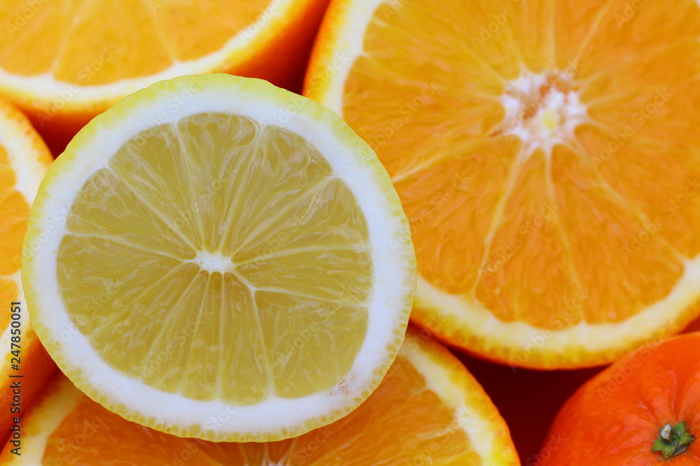 background of cut oranges and a lemon background of cut oranges and a lemon