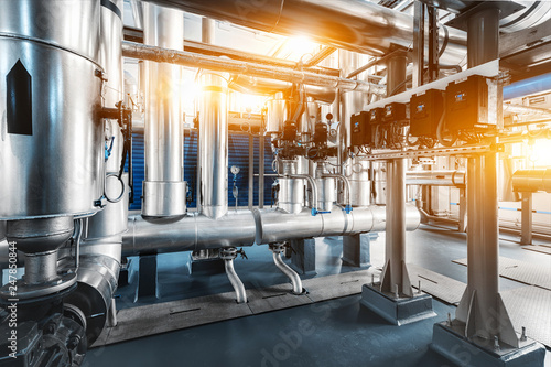 pipe line with steam supply pumps, pressure gauges and control readings installed in the boiler room with back light flare