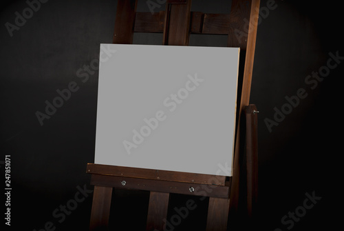 The canvas on the easel on the black background