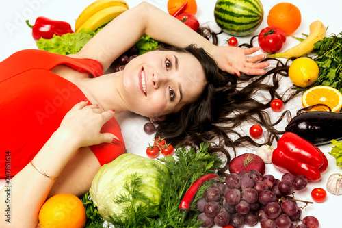 Young woman with fresh various vegetables and fruits