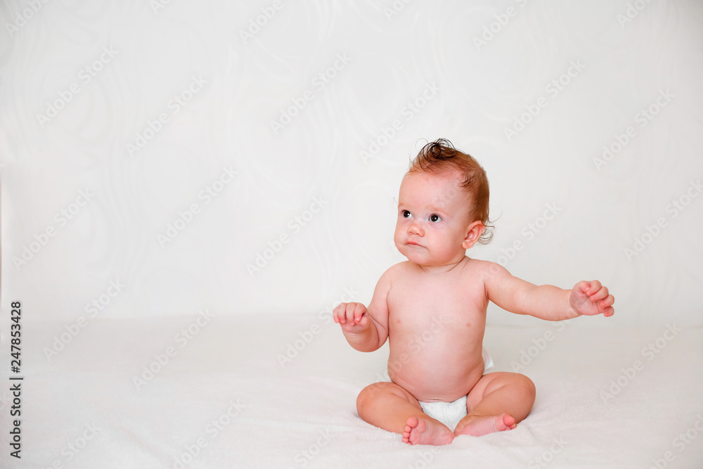 Portrait of cute redhead infant baby in diaper in light bedroom. Family, motherhood, love, health, innocence and care Portrait of cute redhead infant baby in diaper in light bedroom. Family, motherhood, love, health, innocence and care