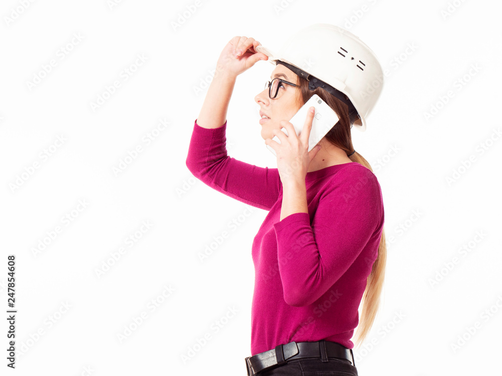 Emotional girl brigadier in a white helmet with glasses and a folder in his hands on a white background Emotional girl brigadier in a white helmet with glasses and a folder in his hands on a white background