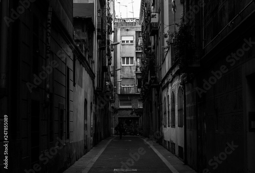 Black and white photo of narrow street in Barcelona in the morning  Catalonia  Spain