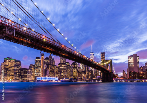 Brooklyn Bridge with skyscrapers background. New York City, USA. Brooklyn Bridge is linking Lower Manhattan to Brooklyn..