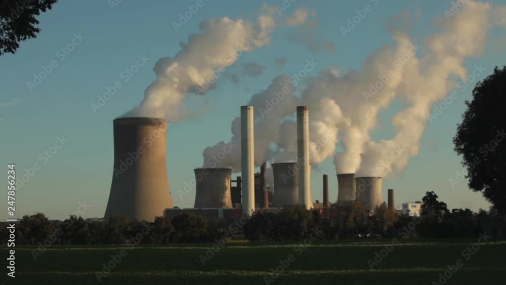 Coal fired power plant producing electric power and air pollution at sunny winter day Coal fired power plant producing electric power and air pollution at sunny winter day