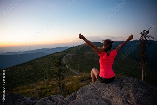 Woman cross country runner on mountain top at summer.