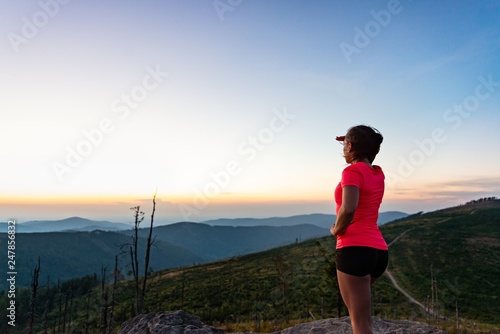 Woman cross country runner on mountain top at summer. © Daniel Jędzura