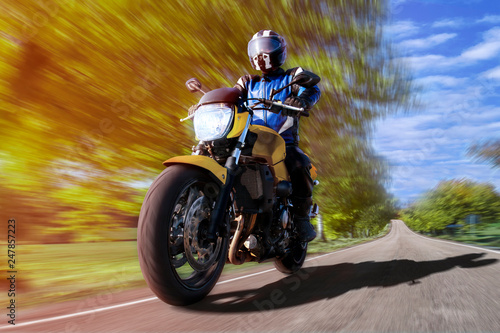 motorcycle riding on highway through countryside. fast motorbike on empty country road rider enjoys freedom