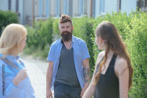 Making a new friendship. Boyfriend dating girlfriends. Making friends on friendship day. Group of friends. Bearded man meeting women on street. Enjoying friendly relations