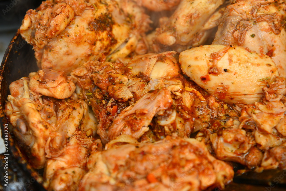 Fried chicken with spices in a pan Fried chicken with spices in a pan