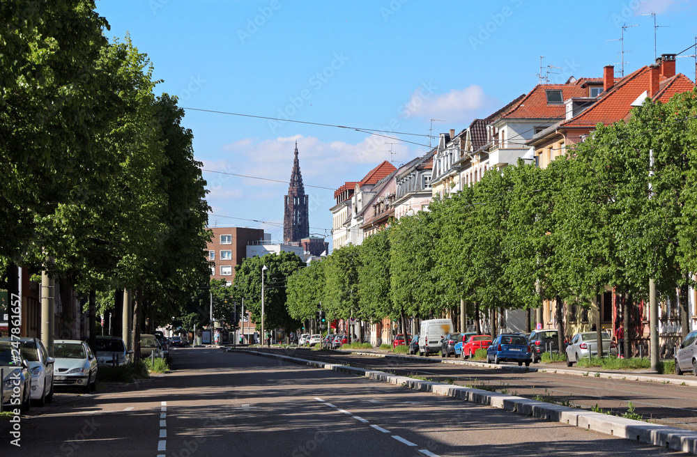 Obraz premium Strasbourg street perspective with monumental Cathedral in the background