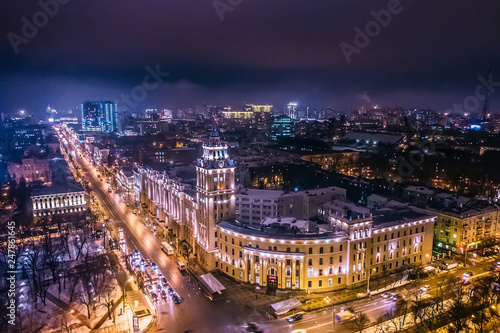 Arial view of Voronezh Main South-Eastern Railway Building tower in night  symbol of Voronezh and evening cityscape with rads  parks and traffic  drone shot