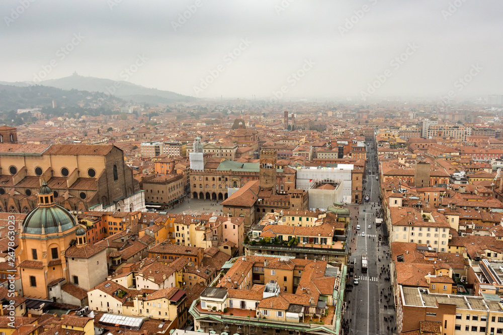 Aerial view of Bologna, Italy and its main square (Piazza Maggiore) on a fogy fall day. Cityscape from Asinelli tower.