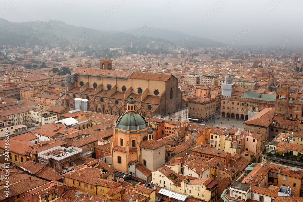 Aerial view of Bologna, Italy and its main square (Piazza Maggiore) on a fogy fall day. Cityscape from Asinelli tower.