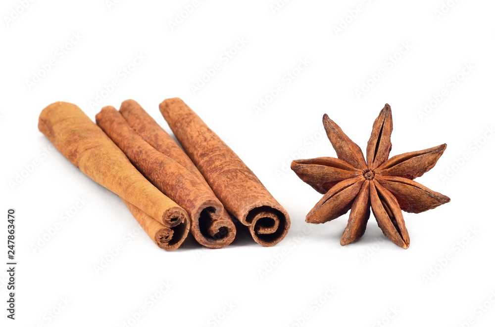 Condiment. Cinnamon sticks and star-anise on white background. Isolated, closeup. Condiment. Cinnamon sticks and star-anise on white background. Isolated, closeup.