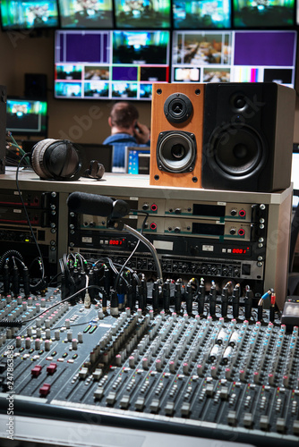 control panel with mixers and microphone in a television studio