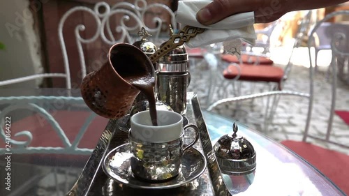 Turkish Coffee poured into the Turkish coffie cup - Slow Motion