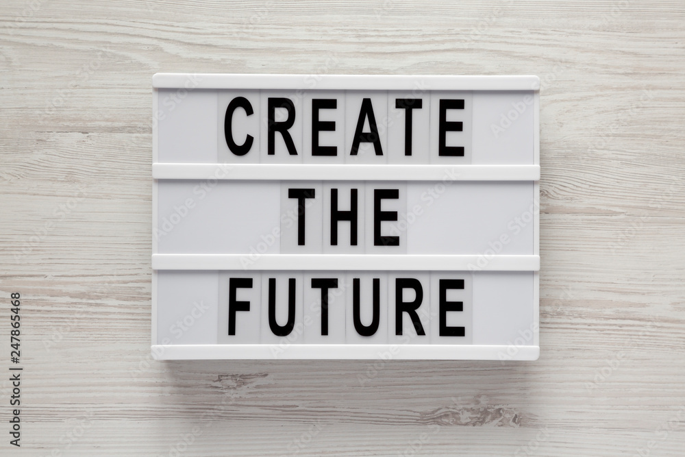 'Create the future' word on lightbox on a white wooden background, top view. From above, flat lay, overhead. 'Create the future' word on lightbox on a white wooden background, top view. From above, flat lay, overhead.