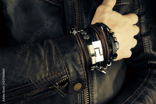 Hand of rocker in leather  bracelet and accessory .Hard rock, heavy metal,gothic and punk style.Brutal jacket