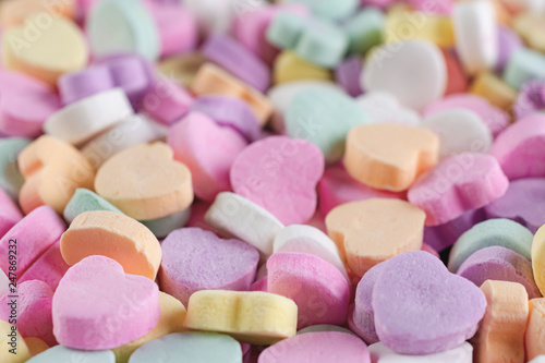 Conversation candy hearts close up side view.  Pastel colors. © Jennifer