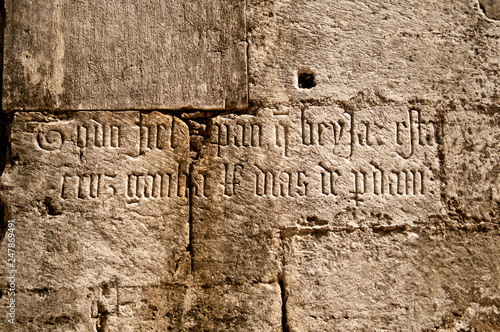 Ancient inscription on wall of cathedral in Madrid, Spain