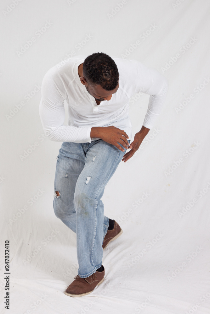 Thoughtful Black man kneeling Thoughtful Black man kneeling