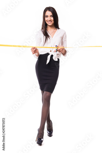 Happy businesswoman ready to cut yellow ribbon opening ceremony, isolated on white background
