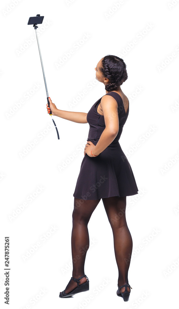 Back view of an African-American woman taking a selfie. Back view of an African-American woman taking a selfie.