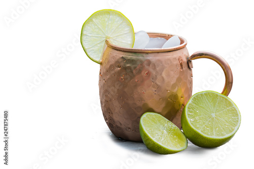 Photography Copper mug with limes for a moscow mule drink