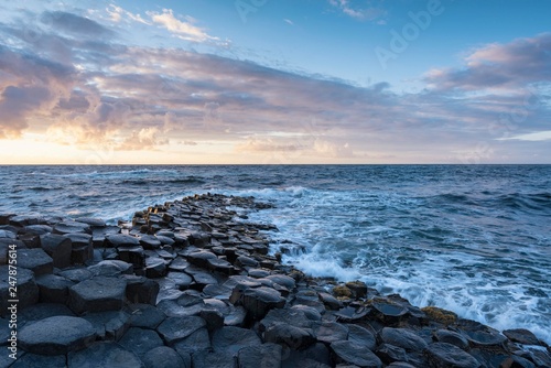 Basalt columns by the coast at sunset, Giant's Causeway, County Antrim, Northern Ireland, United Kingdom, Europe photo