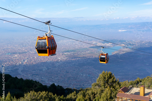 Two ropeway cabs are going up. Denizli, Bagbasi plateau,