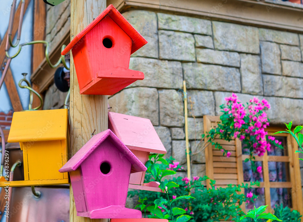 Multicolored nesting boxes outdoor background