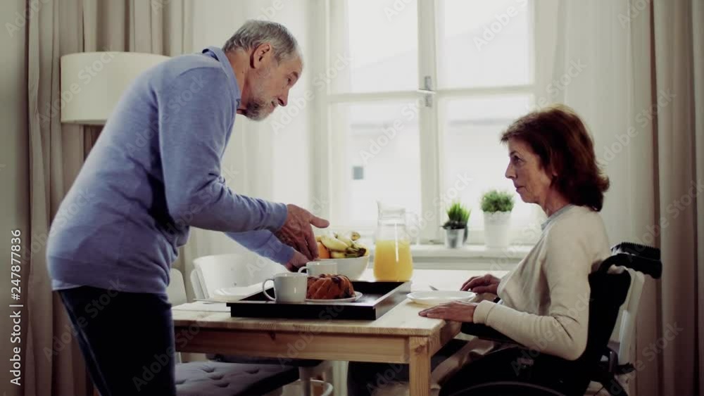 A senior couple sitting at the table at home, having breakfast. A senior couple sitting at the table at home, having breakfast.