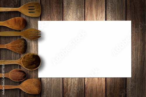 Wallpaper Mural Blank white paper on stripe brown tone wood table surface with wooden utensils around the image
