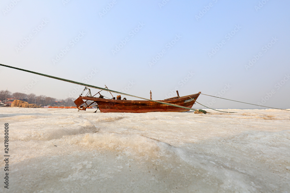 fishing boat in the ice and snow