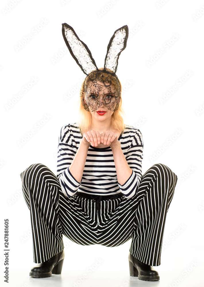 Sexy Easter bunny girl. Sexy girl in black mask. Sensual girl in black bunny  mask. Woman with bunny ears. Woman in striped clothes and bunny ears. Sexy  bunny costume. Sexy pose. foto