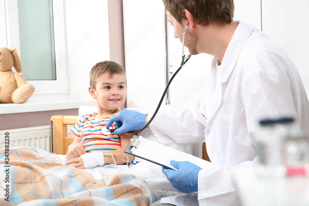 Doctor examining little child with stethoscope in hospital Doctor examining little child with stethoscope in hospital