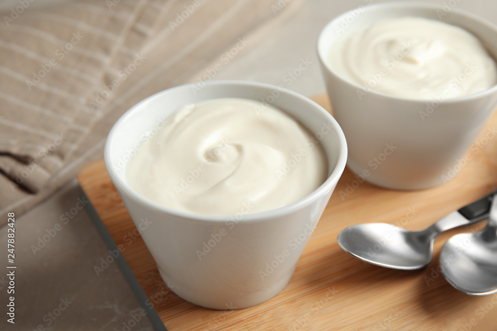 Bowls with creamy yogurt served on table Bowls with creamy yogurt served on table