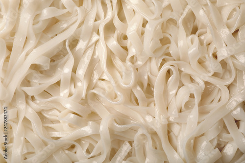 Delicious rice noodles as background, top view