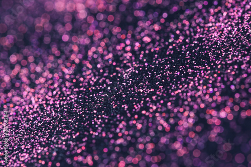 Pink glitter with bokeh effect on dark background