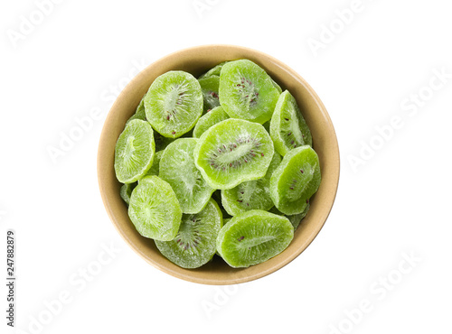 Bowl with slices of kiwi on white background, top view. Dried fruit as healthy food