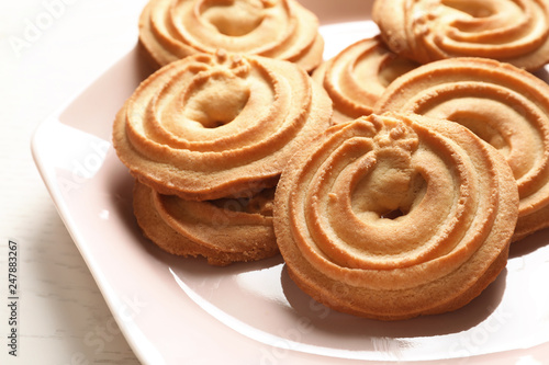 Plate with Danish butter cookies on table, closeup