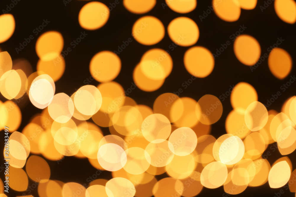 Beautiful golden lights on dark background. Bokeh effect Beautiful golden lights on dark background. Bokeh effect