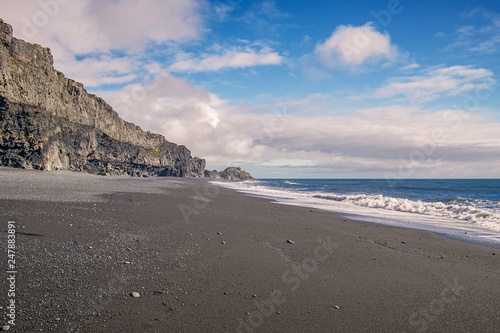 View of Reynisfjara black sand beach on a sunny day.Vik.Southern Iceland