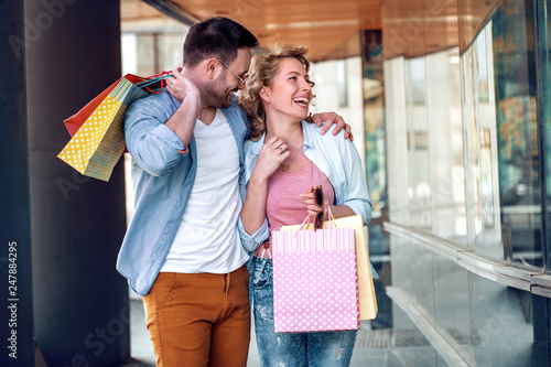 Portrait of a couple with shopping bags in city © ivanko80