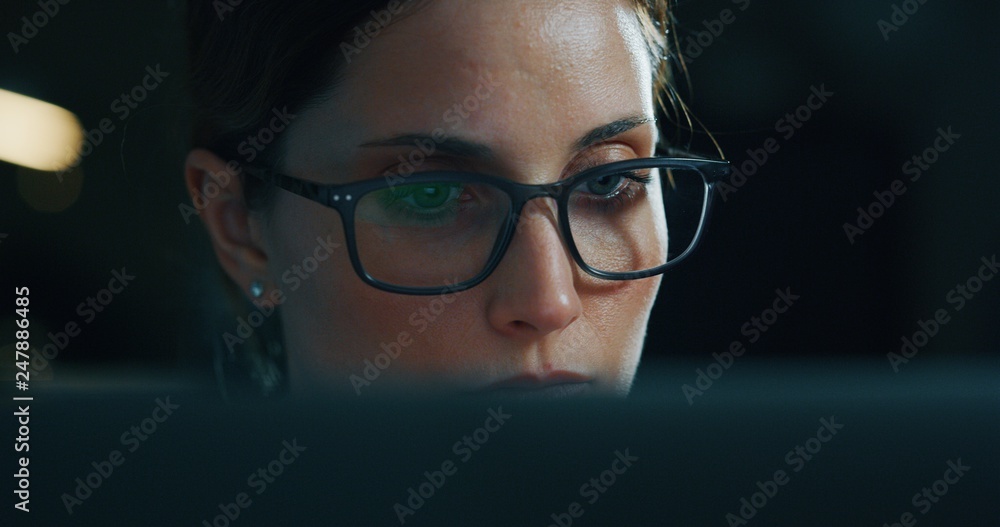 Portrait of a young beautiful business woman working with a computer in a office. Concept of technology, business and finance, economy, management, success