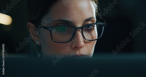 Portrait of a young beautiful business woman working with a computer in a office. Concept of technology, business and finance, economy, management, success