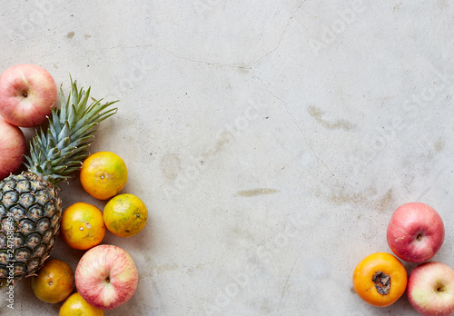 Fototapeta Naklejka Na Ścianę i Meble -  Fresh fruits frame on a gray concrete