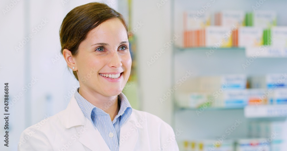 Portrait of a beautiful young woman pharmacist consultant smiling in camera. Concept of profession, medicine and healthcare, medical education, pharmaceutical sector Portrait of a beautiful young woman pharmacist consultant smiling in camera. Concept of profession, medicine and healthcare, medical education, pharmaceutical sector